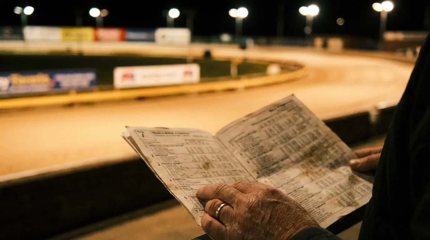 Greyhound race card with form lines and trap numbers at a UK dog track